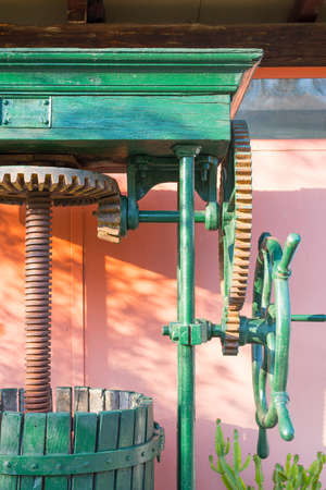 Vintage olive press, traditionally used to make oil in the mediterranean area, with his wooden...
