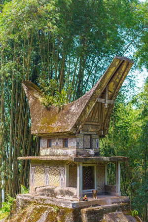 Tipical boat shaped roofs of an ancient traditional grave in bamboo woodland, Tana Toraja, South Sulawesi, Indonesia.の写真素材