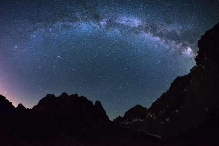 The outstanding beauty of the Milky Way arc and the starry sky captured at high altitude in summertime on the Italian Alps, Torino Province. Fisheye scenic distortion and 180 degree view.の写真素材