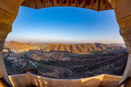 Framed view of the impressive landscape and cityscape from above at Amber Fort, famous travel destination in Jaipur, Rajasthan, India. Fish eye and ultra wide angle view.の写真素材