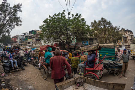 Delhi, India - December 11, 2017: crowd and traffic on street at Chandni Chowk, Old Delhi, famous travel destination in India. Chaotic city life, working people, fisheye ultra wide view.のeditorial素材