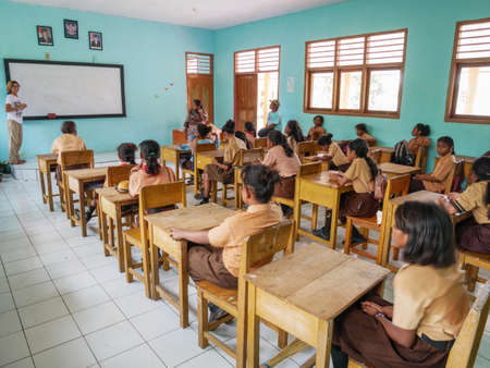 Kei Kecil, Indonesia - October 20, 2018: european teacher holding class in local school, Ngilgof village, Kei Islands, Moluccas, Indonesiaのeditorial素材
