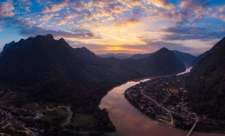 Aerial panoramic Nam Ou River Nong Khiaw Muang Ngoi Laos, sunset dramatic sky, scenic mountain landscape, famous travel destination in South East Asiaの写真素材