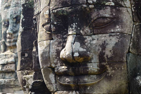 Bayon, Angkor Thom temple, world famous travel destination, Cambodia tourism. Details of Stone faces sculpture and rock carvings. Buddhism meditation concept.の写真素材