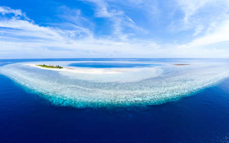 Aerial idyllic atoll, scenic travel destination Maldives Polinesia. turquoise coral reef. Shot in Wakatobi National Park, Indonesiaの写真素材