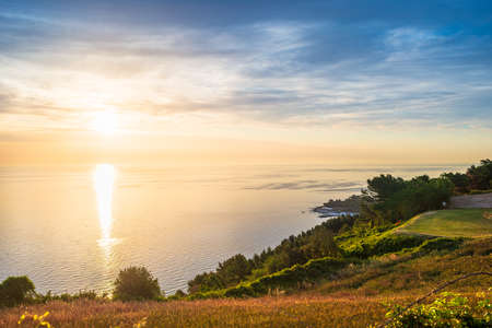 Sunset landscape Conero natural park dramatic coast headland rocky cliff adriatic sea beautiful sky colorful horizon, tourism destination Italyの写真素材