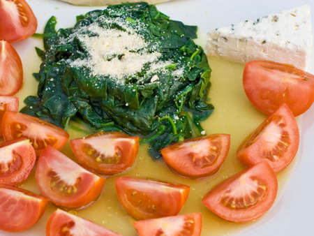 Spinach and Tomatoes shot in natural light, simple italian cuisineの写真素材