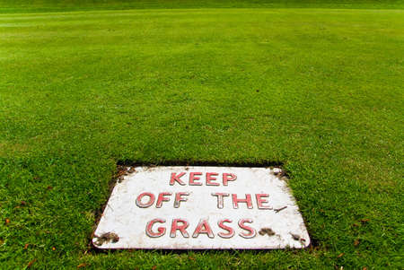 Keep off the grass sign on the grass itselfの写真素材