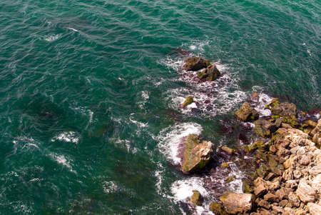 Downward view of the sea splashing on Cape Kaliara, Bulgaria.の写真素材