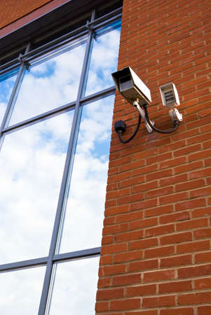 Security camera looking out from a window reflecting sky