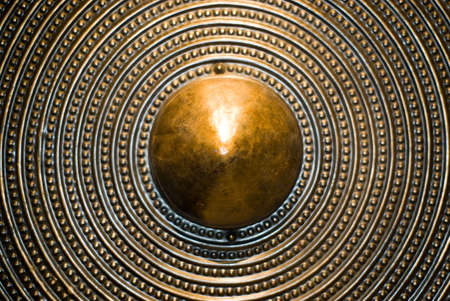 Bronze shield background. Selective focus. Shallow depth of field.の写真素材