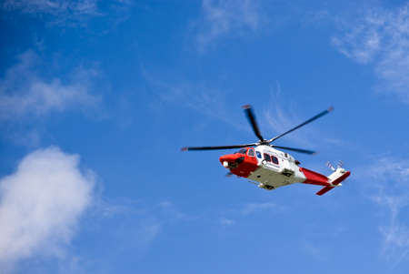 Coastguard helicopter in the blue skyの写真素材
