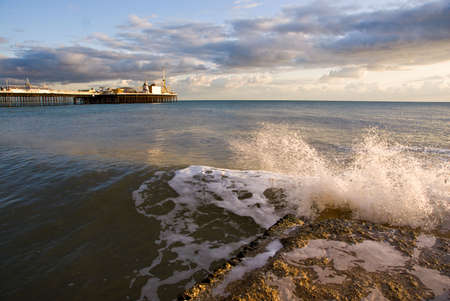 Wave crashing on small pier in Brighton.の写真素材