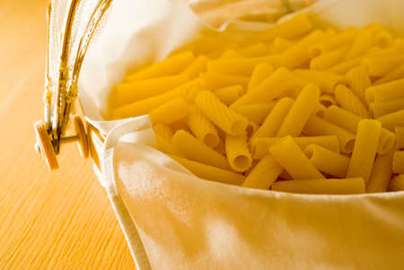 Italian dried pasta in a wooden chest. Warmed tone.の写真素材