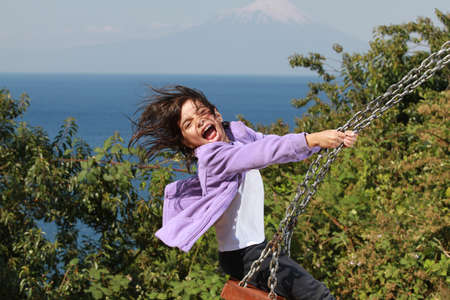 Girl on a swing - Puyehue National Park and Osornoの写真素材