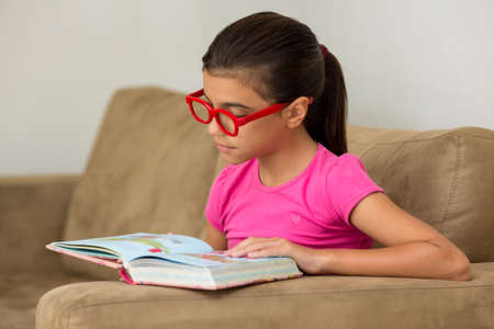 Young girl reading focusedの写真素材