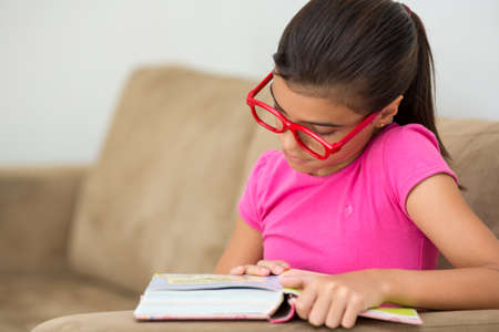 Young girl reading concentratedの写真素材