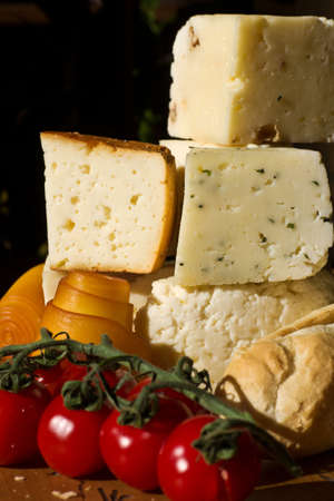 Cheese composition with tomatos on a wooden tableの写真素材