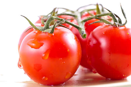 Fresh cherry tomatoes isolated on white backgroundの写真素材