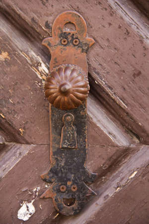 Ancient door handle of a wooden doorの写真素材