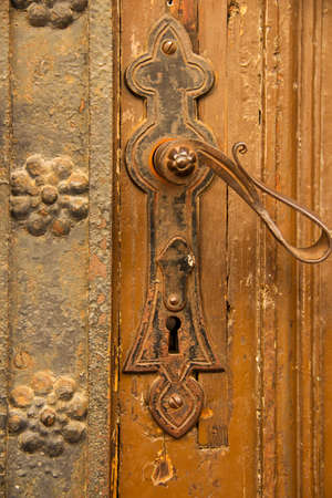 Ornate door handle with wrought iron decorationの写真素材