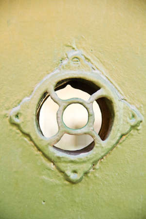 Little window of an old wooden door