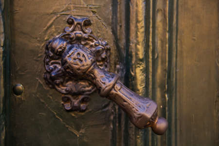 Old door handle made of ironの写真素材