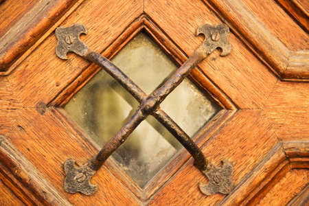 Little window with grid of a wooden doorの写真素材