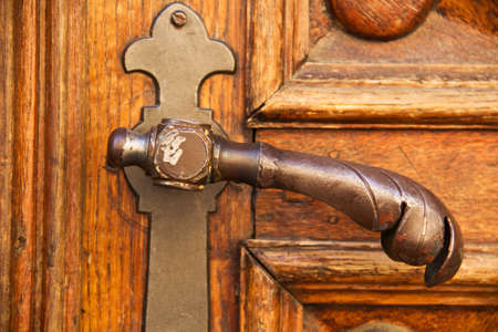 Ancient door handle of a wooden doorの写真素材