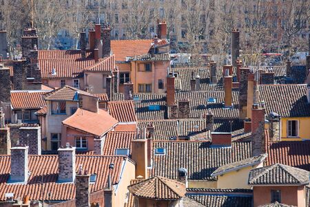 Aerial view of the tiled rooftops and chimneys of the old town of Lyon, France.の写真素材
