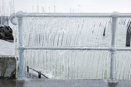 Fence covered with icicles after a winter storm on Lake Geneva.