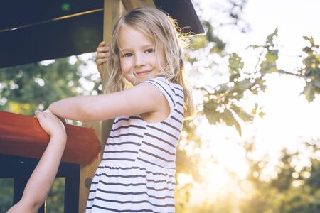 Blond girl at a playground.の写真素材