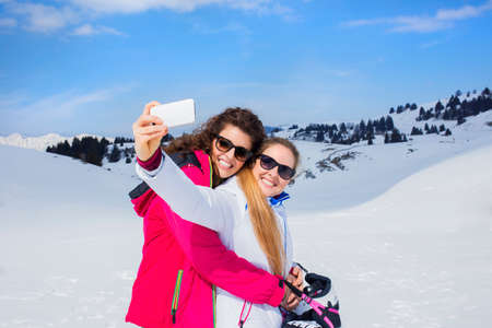 friends having a selfie on the snowの写真素材