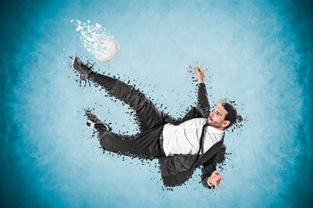 business man making a spectacular movement with the ballの写真素材