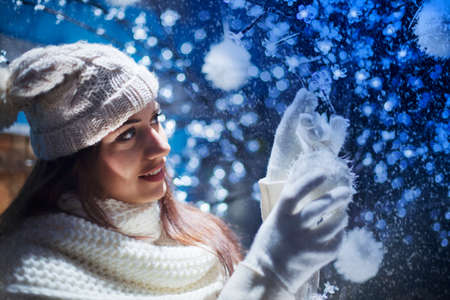 beautiful girl decorates the Christmas tree