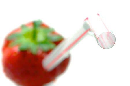Strawberry with straw illustrating a healthy dietの写真素材
