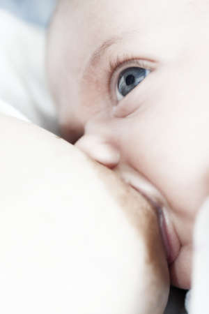 mother breast-fed her infant and the newborn watch the motherの写真素材