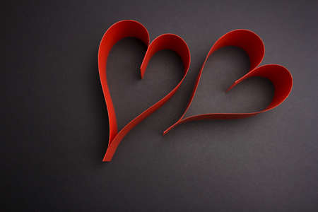 Valentine's Day two red hearts on dark background