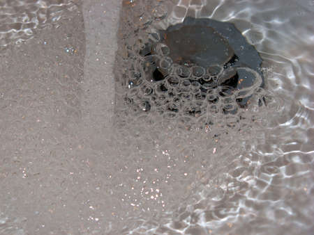 Running drinkable water running in the bathroom sinkの写真素材