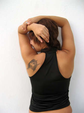 Young woman' s back with tatoo isolatedの写真素材