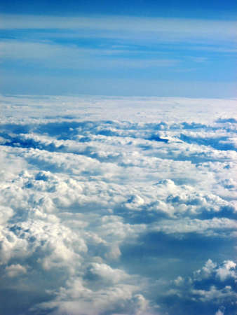 Blue sky above the clouds while flying under the sun