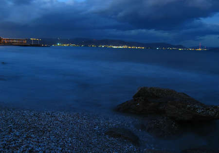 A beautiful beach at the sunset with rocks in the foregroundの写真素材