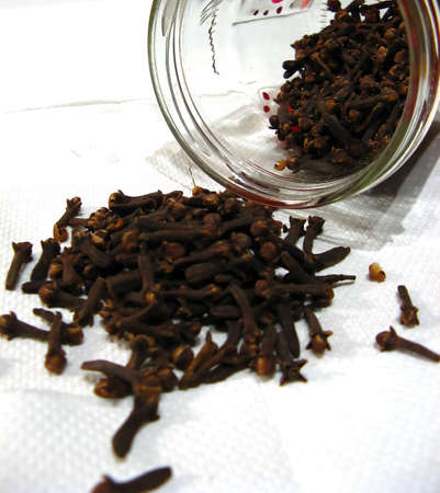 Spice thrown out of a glass bottle isolated on white backgroundの写真素材