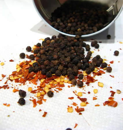 Red spicy and black pepper isolated on white background