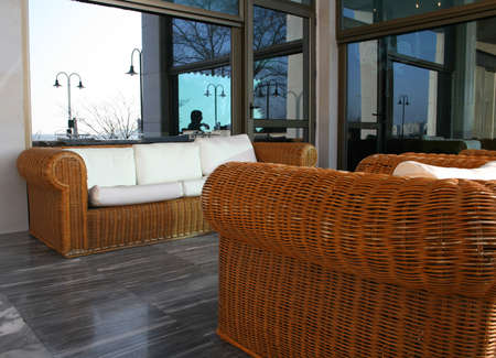 Bamboo outdoors sofa with several white cushions の写真素材