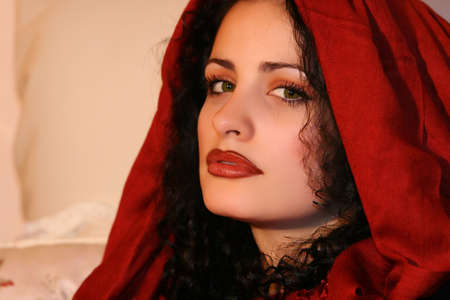 A beautiful young brunette female with red scarfの写真素材