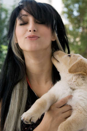 A woman holding a puppyの写真素材