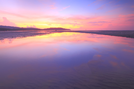 Colorful sunset on a beach with reflectionの写真素材