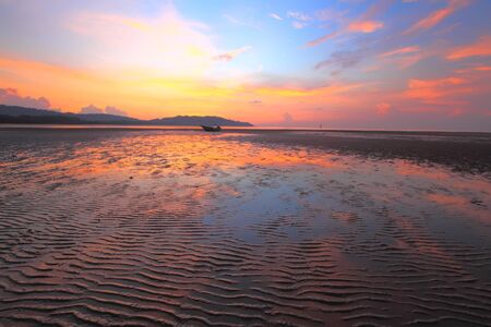 Colourful Sunrise Seascape with reflection on the sandの写真素材
