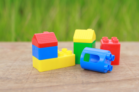 Plastic building blocks isolated on green backgroundの写真素材